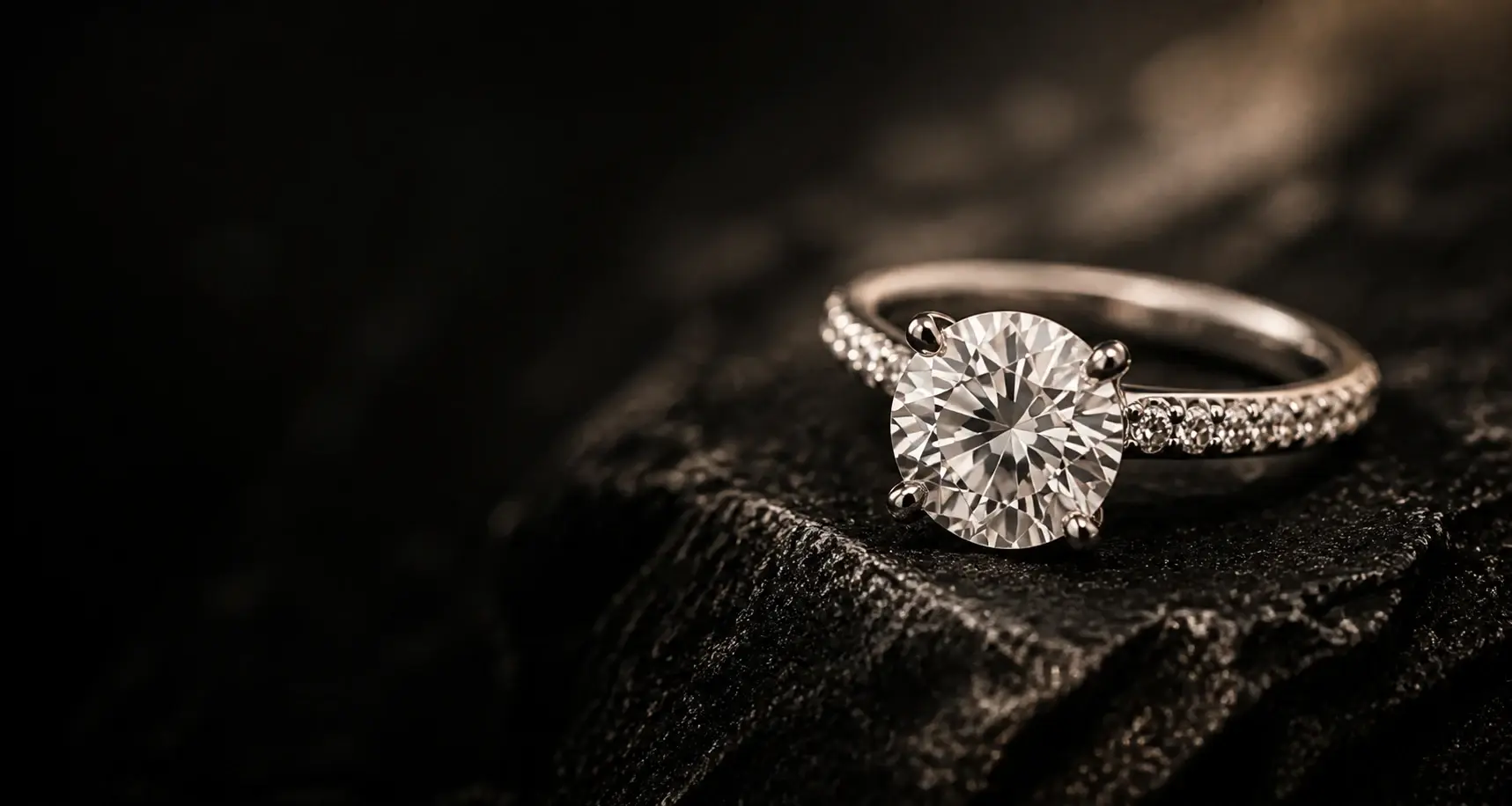 Round brilliant diamond ring on dark mineral stone